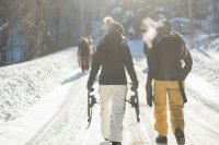People walking with ski equipment