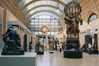 People admiring statues in French museum