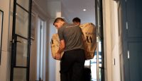People moving package through house