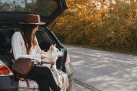 Person and dog taking rest in a boot of a car