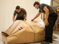 People wrapping package for export in warehouse
