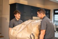 People moving packaged furniture
