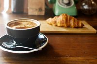 Coffee and croissant on a table
