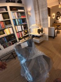 A Williams & Yates technician collecting a wrapped chair from a showroom